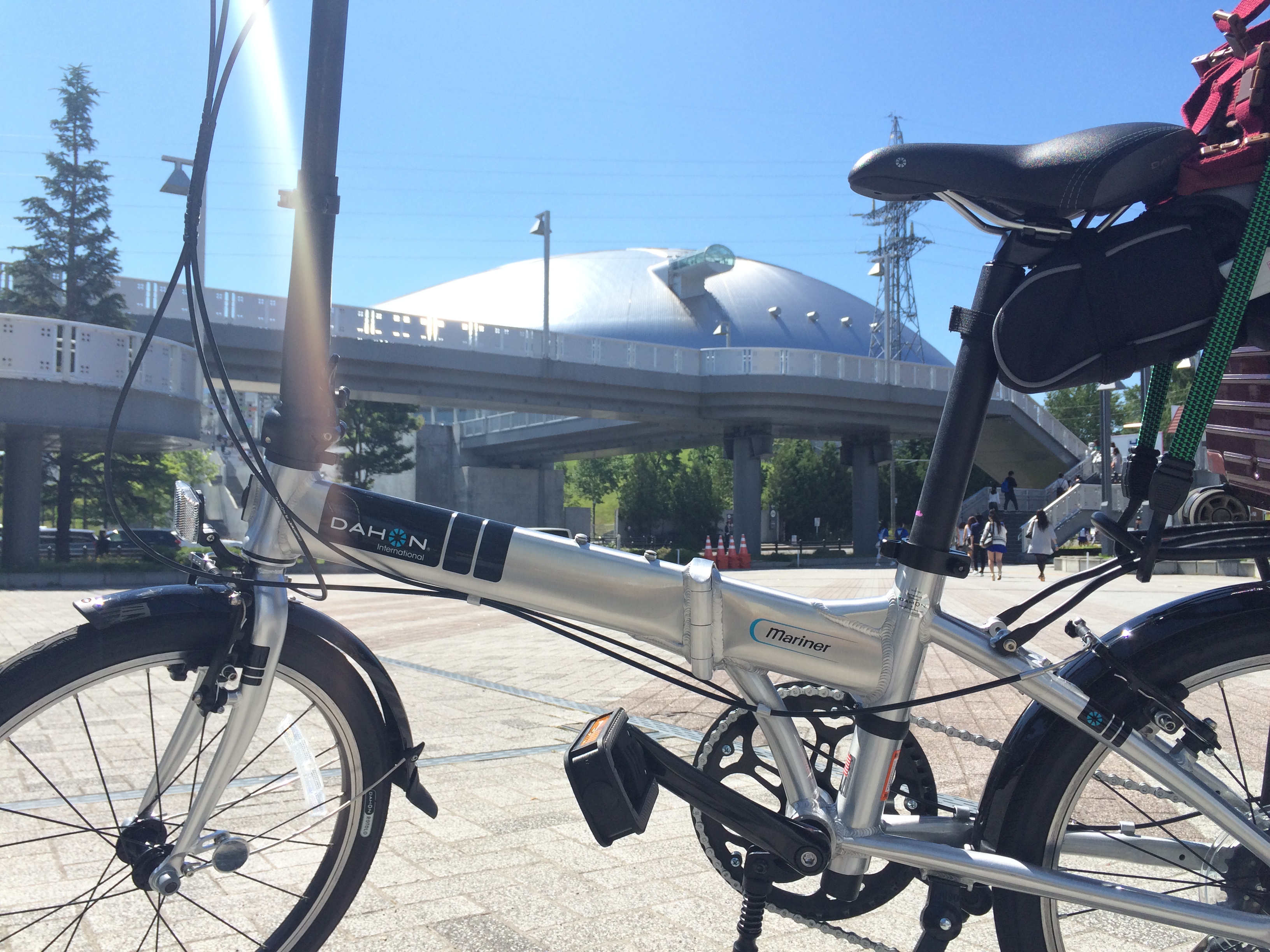 札幌ドームを背景にした折りたたみ自転車。